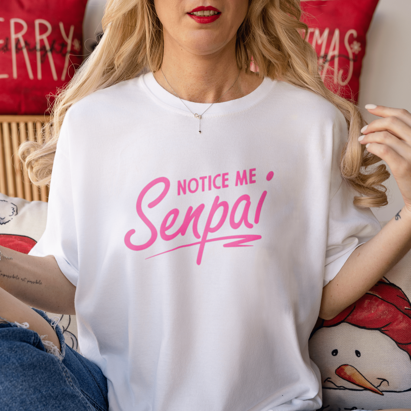 a blonde hair woman wearing 180gsm white unisex cotton tshirt sitting on bed christmas decorations