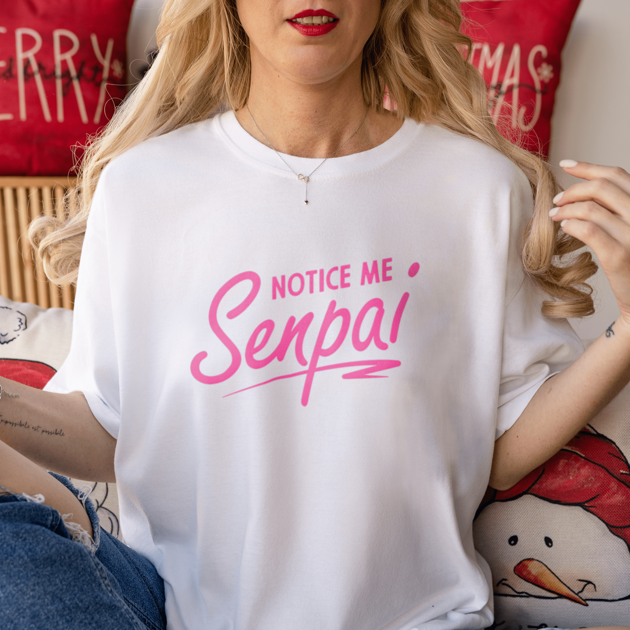 a blonde hair woman wearing 180gsm white unisex cotton tshirt sitting on bed christmas decorations