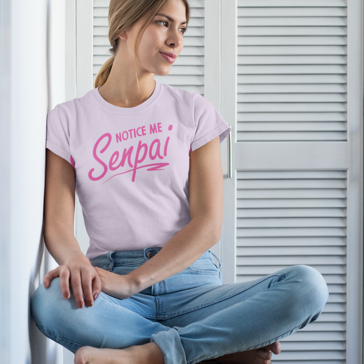 a blonde girl sitting on  a chair wearing a light pink color crew neck 180 gsm unisex tshirt