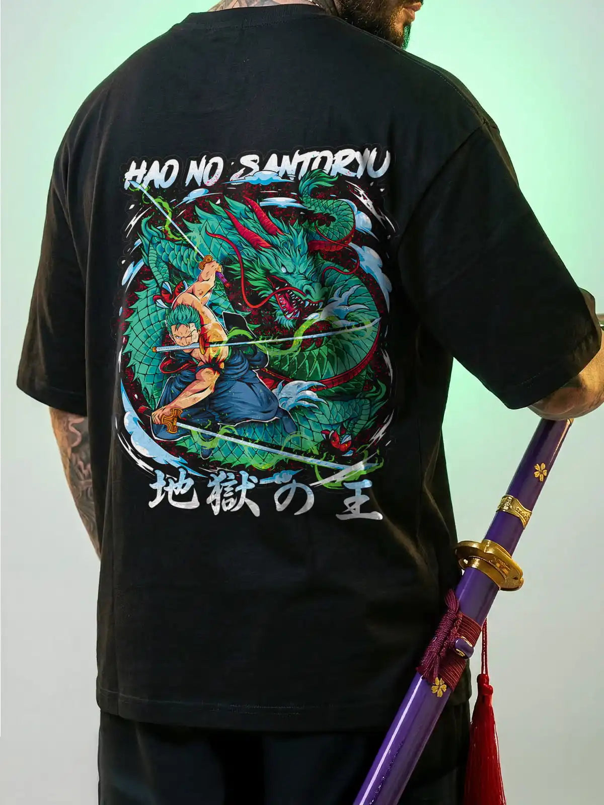 Person wearing a black t-shirt with a colorful dragon design on the back, holding a sword.